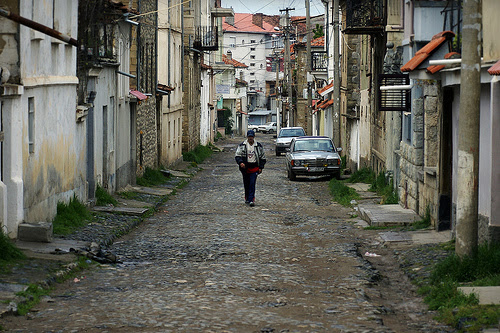 A man walking on a narrow street in Albania